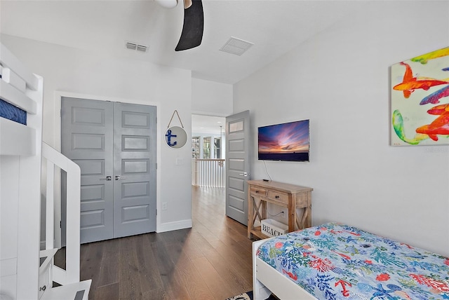 bedroom with ceiling fan, dark hardwood / wood-style flooring, and a closet