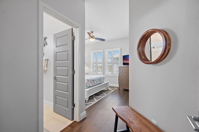 hallway with hardwood / wood-style flooring