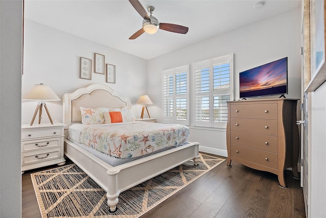 bedroom with dark hardwood / wood-style floors and ceiling fan