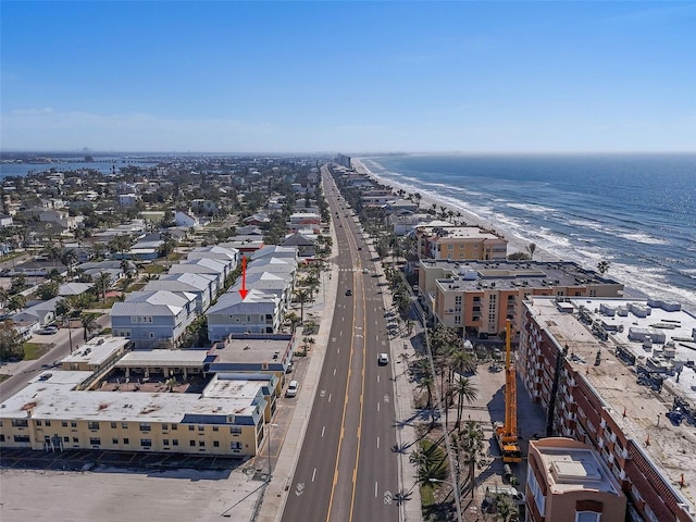 birds eye view of property with a water view and a view of the beach