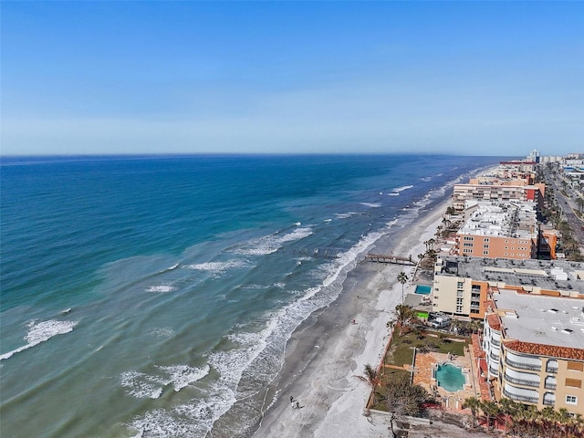 birds eye view of property with a beach view and a water view