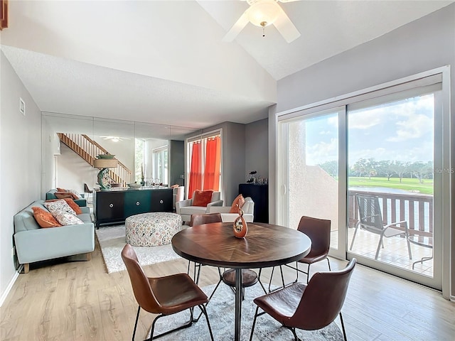 dining room featuring lofted ceiling, ceiling fan, and light wood-type flooring