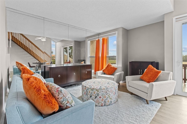 living room featuring a textured ceiling and light wood-type flooring