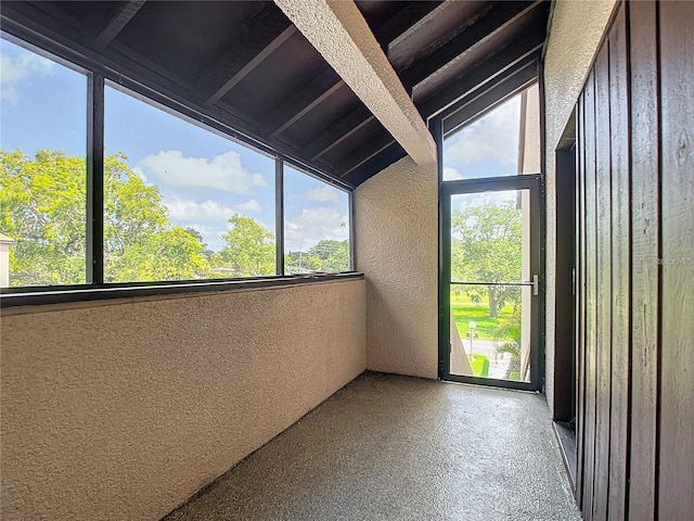 unfurnished sunroom with vaulted ceiling