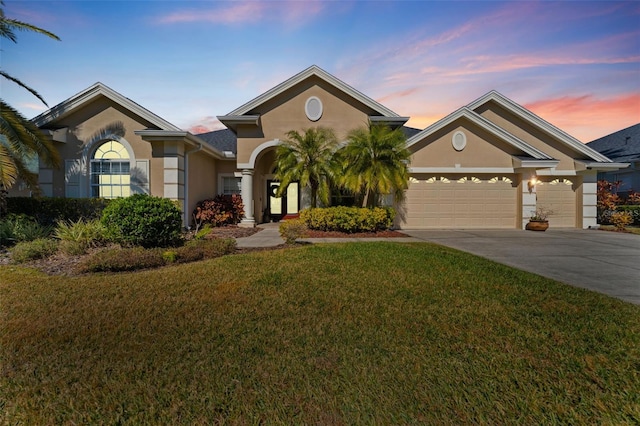 view of front of home featuring a garage and a lawn