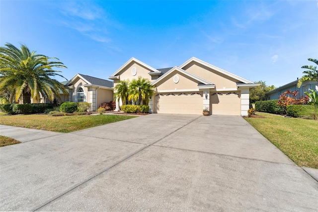 view of front of home with a garage and a front lawn