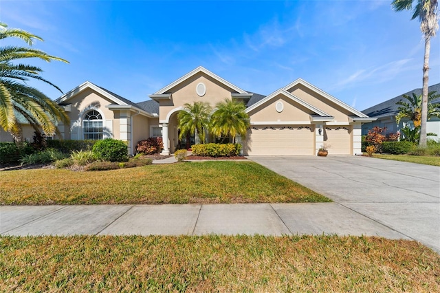 view of front of house with a garage and a front lawn