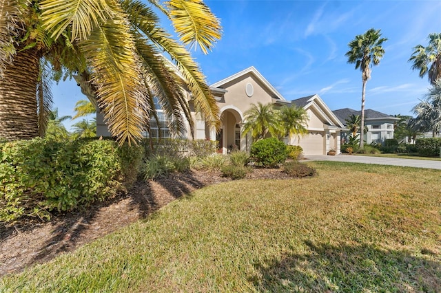 view of front of home with a garage and a front yard