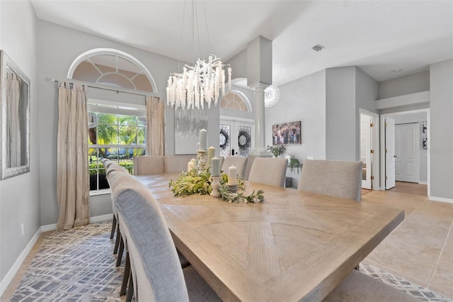 tiled dining room with an inviting chandelier and ornate columns