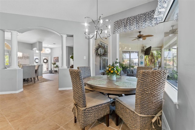 tiled dining room with decorative columns and ceiling fan