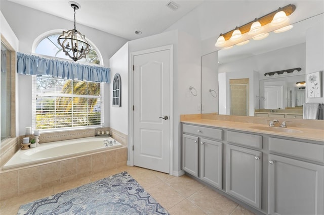 bathroom with tile patterned flooring, vanity, separate shower and tub, and a notable chandelier