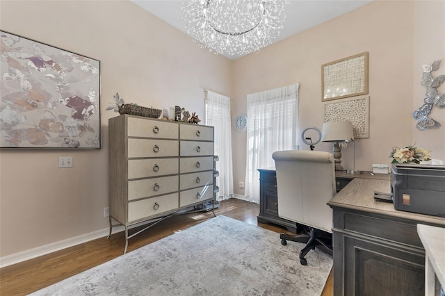 office area with a notable chandelier and dark hardwood / wood-style floors