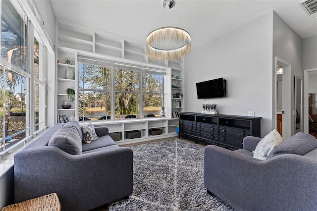 living room featuring built in shelves and plenty of natural light