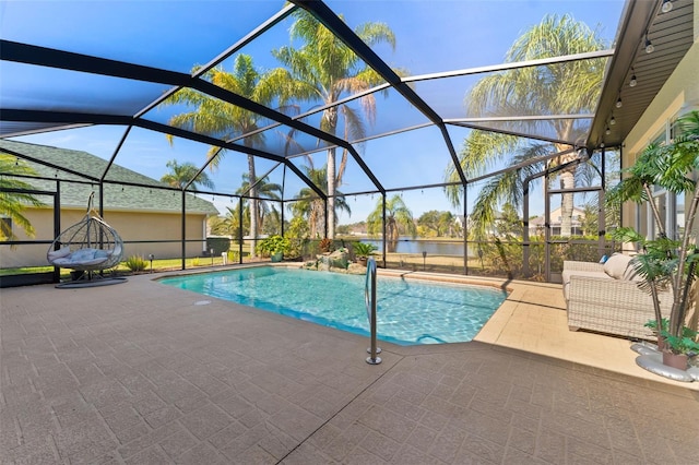 view of swimming pool featuring a patio and a lanai