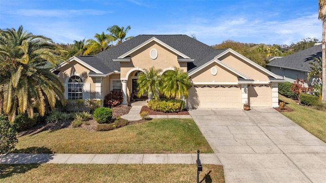 view of front of house featuring a garage and a front lawn