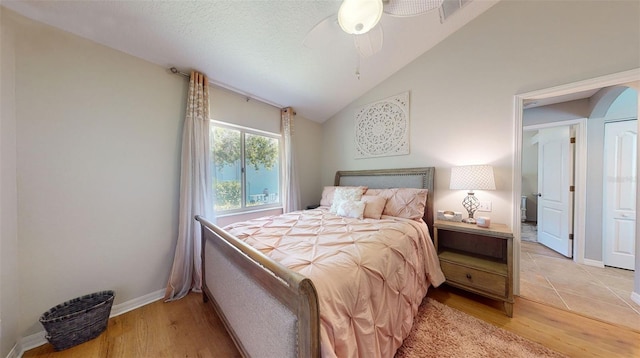 bedroom featuring vaulted ceiling, ceiling fan, and light wood-type flooring