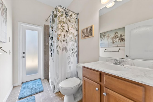 bathroom with vanity, tile patterned floors, and toilet