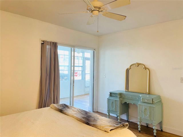 bedroom with a ceiling fan, baseboards, and wood finished floors