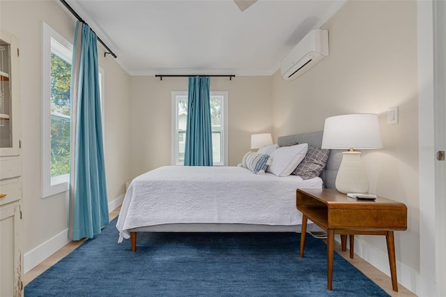 bedroom with multiple windows and a wall mounted air conditioner