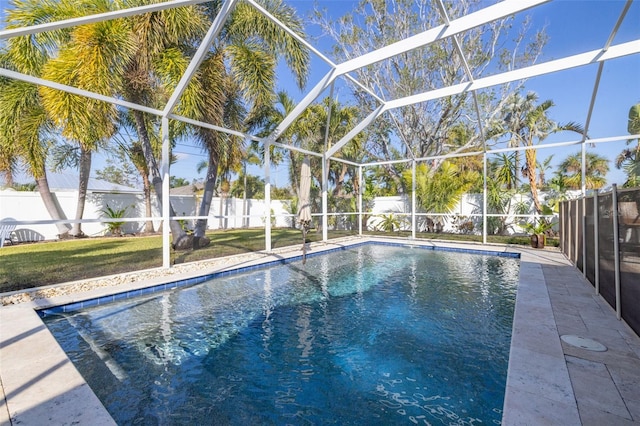 view of pool featuring a yard and glass enclosure