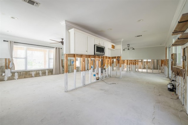 interior space featuring crown molding and ceiling fan