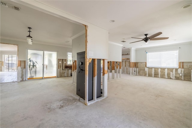 unfurnished room featuring ornamental molding, plenty of natural light, and ceiling fan