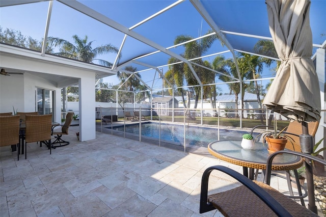 view of pool with a patio and glass enclosure