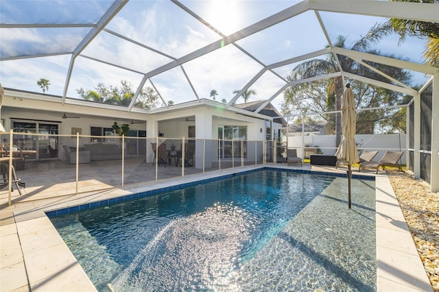 view of swimming pool with a patio, outdoor lounge area, ceiling fan, and glass enclosure