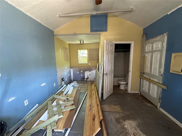 kitchen featuring ceiling fan and lofted ceiling