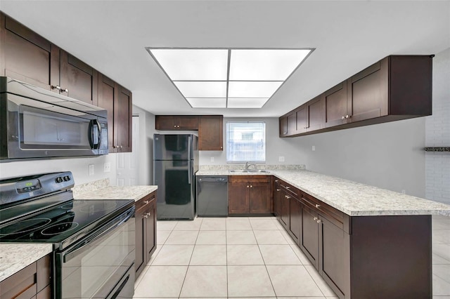 kitchen with dark brown cabinetry, sink, light tile patterned floors, and black appliances