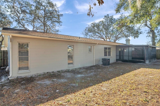 rear view of house featuring a sunroom