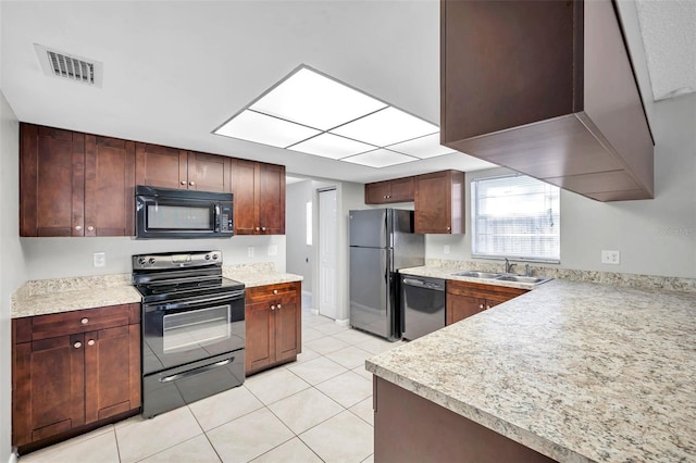 kitchen featuring light tile patterned flooring, sink, and black appliances