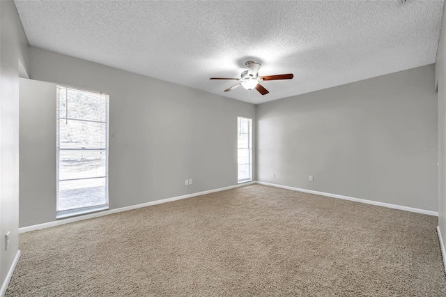 unfurnished room featuring ceiling fan, carpet flooring, and a textured ceiling