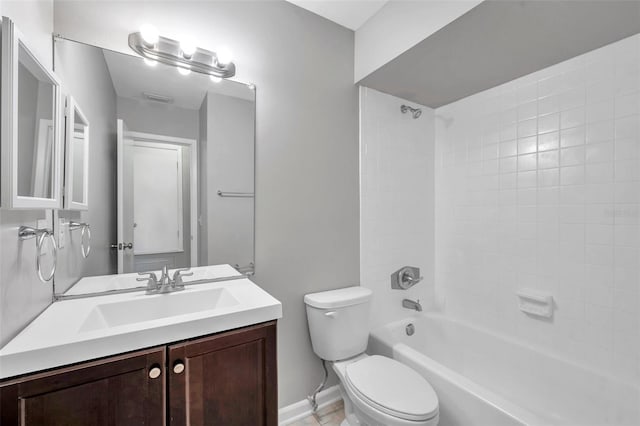 full bathroom with vanity, tiled shower / bath combo, and toilet