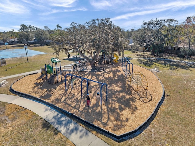 surrounding community featuring a playground and a lawn