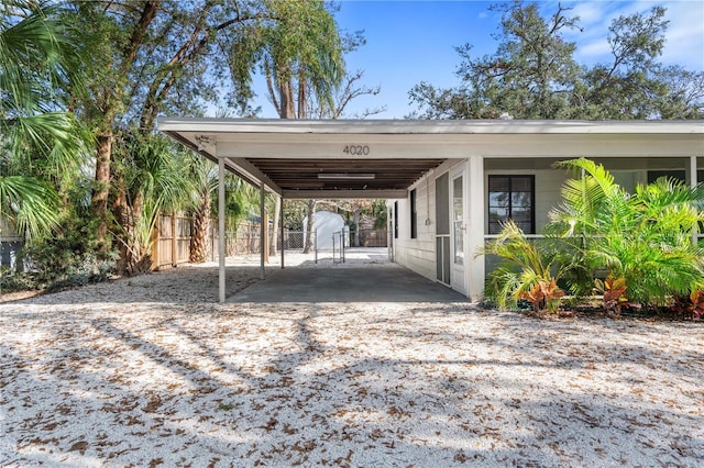 view of vehicle parking with a carport