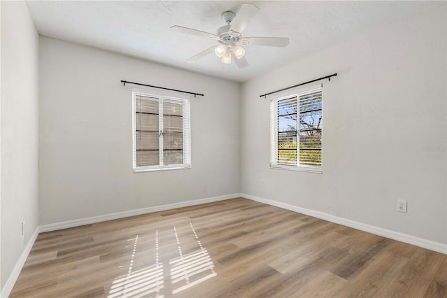 empty room featuring ceiling fan and light hardwood / wood-style floors