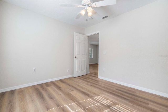 empty room with light hardwood / wood-style floors and ceiling fan