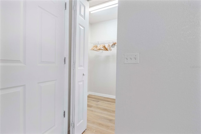 corridor with light wood-type flooring