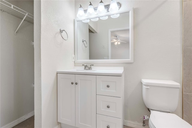 bathroom featuring vanity, ceiling fan, and toilet