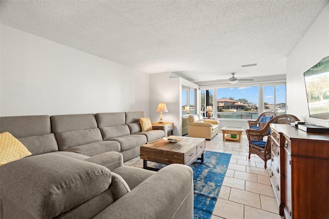 tiled living room featuring ceiling fan and a textured ceiling