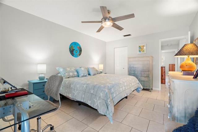 bedroom featuring a closet, ceiling fan, and light tile patterned flooring