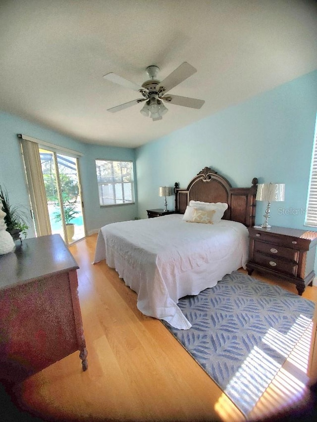 bedroom with access to exterior, light wood-style flooring, and a ceiling fan