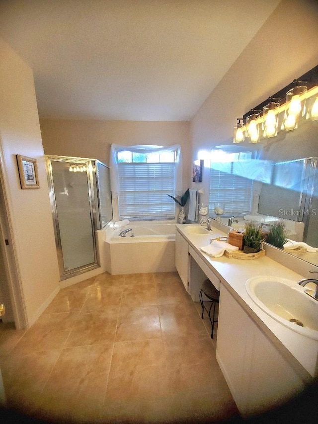 bathroom with double vanity, a sink, a shower stall, and a bath