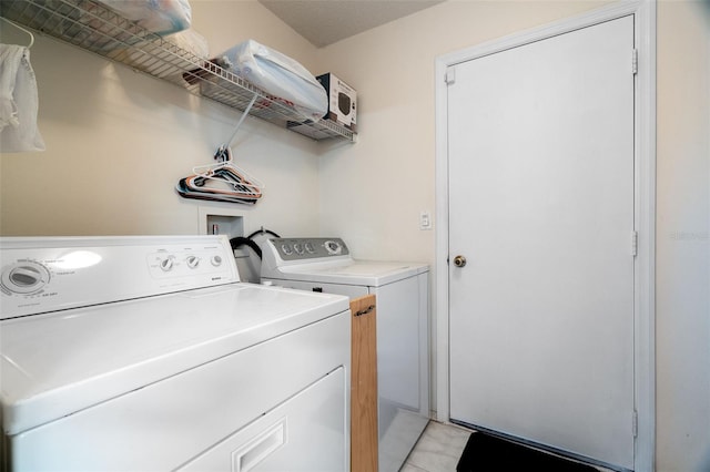 clothes washing area with washer and dryer