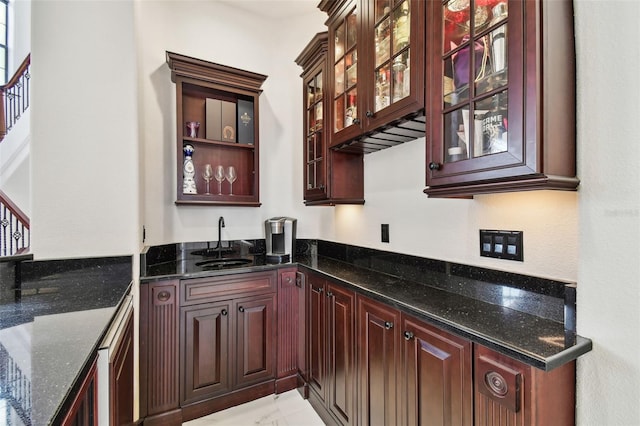 kitchen featuring sink and dark stone countertops