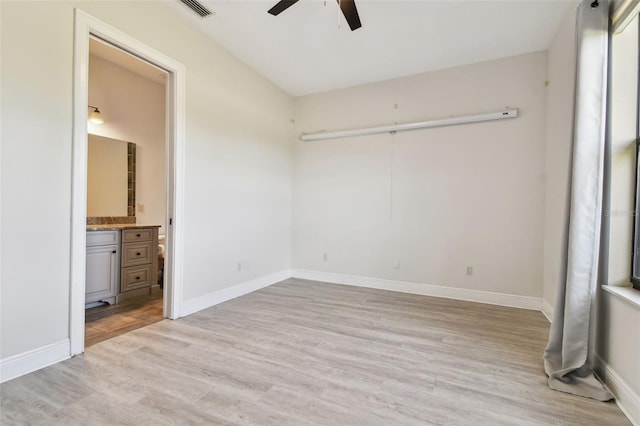 unfurnished bedroom featuring ensuite bathroom, ceiling fan, and light hardwood / wood-style floors