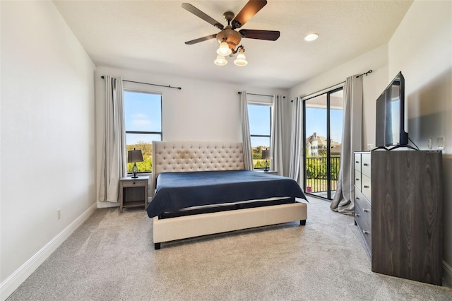 carpeted bedroom featuring ceiling fan, access to exterior, and multiple windows