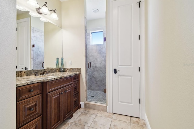 bathroom featuring vanity, tile patterned floors, and a shower with door