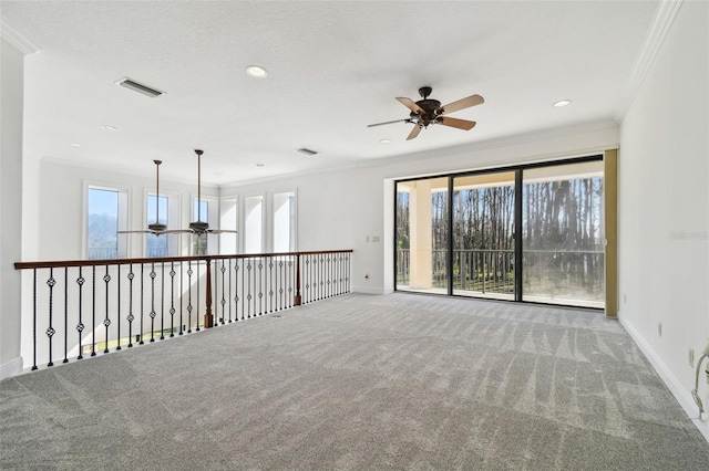 carpeted spare room with ornamental molding and ceiling fan